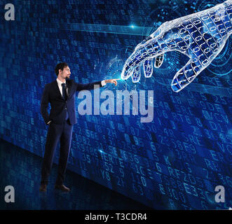 Man machine interaction between human and a digital hand Stock Photo