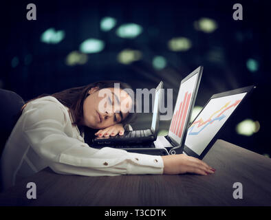 Female worker falls asleep while simultaneously working on three laptops Stock Photo