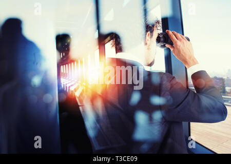 Businessman looks far for new job opportunities with binoculars. Double exposure effect Stock Photo