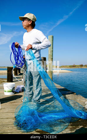 A man prepares to throw a cast net for fish in Bayou La Batre, Alabama, Nov. 23, 2012. Stock Photo