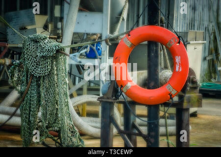 A life preserver and shrimp net are pictured at Dominick’s Seafood, March 4, 2017, in Bayou La Batre, Alabama. Stock Photo