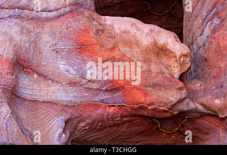 The multi-colored exposed sandstone rock and mineral layers inside the ancient tombs of Petra, Jordan. Sandstone pattern, geological texture in Petra, Stock Photo