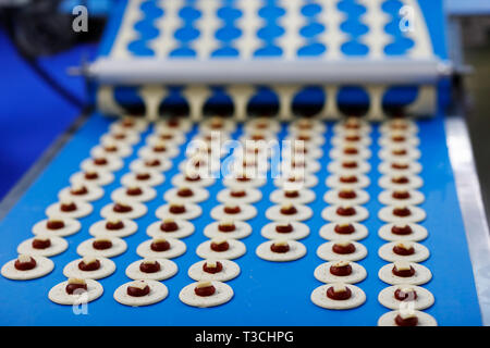 Production line of cheese and jam crackers. Selective focus. Stock Photo