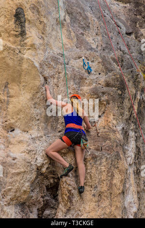 South asian young woman rock climbing in the desert Stock Photo - Alamy