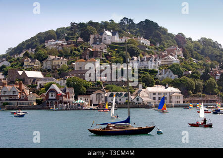 A couple (male & female), enjoy the view across the River Dart estuary to Kingswear from the balcony of their house in Dartmouth,Devonshire,UK Stock Photo