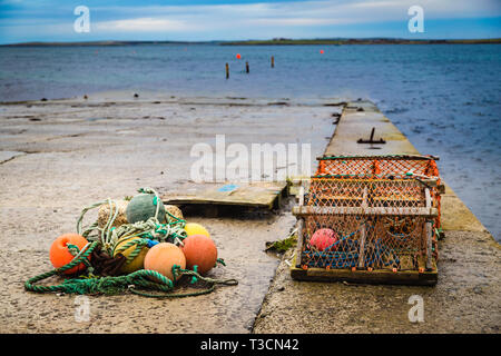 Lobster creels and buoys on a slipway in Kirkwall, Orkney Islands. Stock Photo