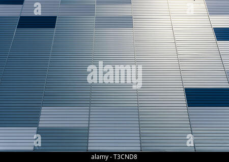 Abstract architectural background from modern buildings facade with blue and silver lines - image Stock Photo