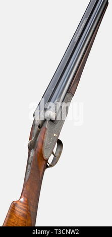 A splendid side-by-side shotgun, Martin Kruschitz jun. in Vienna, circa 1973, 12/70 cal., no. 25.2181. Mirror-like bores, only most minimal usage marks, finish thin in places, inscribed: 'BÖHLER RASANT' and in gold on the machined midrib 'M. KRUSCHITZ-WIEN', 1973 Vienna proof mark, choke 3/4, 1/1, white bead sight, length 67.5 cm. Greener bolt with double barrel hook locking, real side locks à la Holland & Holland with gilded cocking levers, striking pieces, trigger and catch bars, gilded double trigger, jointed front trigger, slide safety on sma, Additional-Rights-Clearance-Info-Not-Available Stock Photo