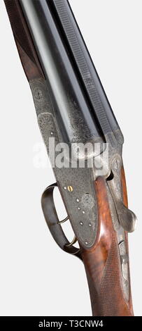 A splendid side-by-side shotgun, Martin Kruschitz jun. in Vienna, circa 1973, 12/70 cal., no. 25.2181. Mirror-like bores, only most minimal usage marks, finish thin in places, inscribed: 'BÖHLER RASANT' and in gold on the machined midrib 'M. KRUSCHITZ-WIEN', 1973 Vienna proof mark, choke 3/4, 1/1, white bead sight, length 67.5 cm. Greener bolt with double barrel hook locking, real side locks à la Holland & Holland with gilded cocking levers, striking pieces, trigger and catch bars, gilded double trigger, jointed front trigger, slide safety on sma, Additional-Rights-Clearance-Info-Not-Available Stock Photo