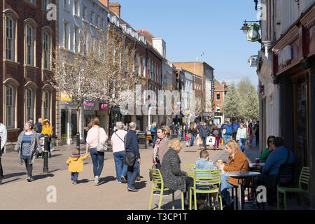 People drinking coffee outside on a spring day on Worcester High Street, England Stock Photo