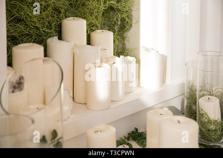Many candles and flower petals to celebrate the wedding ceremony.decorative candles on table on sunny light.wax candle as Christmas decorations or spa Stock Photo