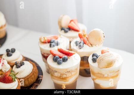 Cake with various berries and meringues on a stand.cakes, dessert with berries, candy bar for party. wedding or happy birthday.Delicious sweets on Stock Photo
