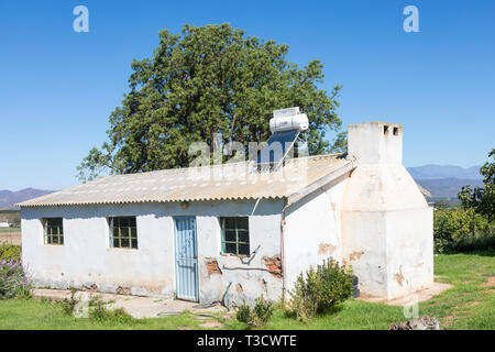 Farmworkers cottage with small roof mounted solar hot water geyser and photovoltaic panel, natural resource, renewable, sustainable, power, energy, he Stock Photo