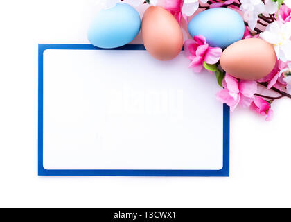 Easter greeting card with pastelcolored eggs and spring flowers. frame background Stock Photo