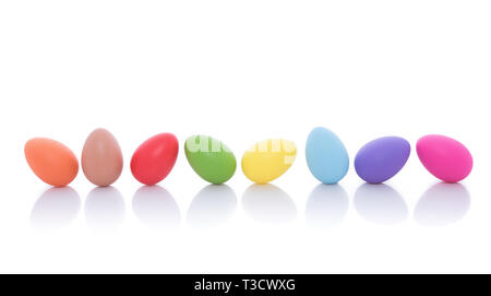 Bright colorful Easter eggs lined up in a row on a white background Stock Photo