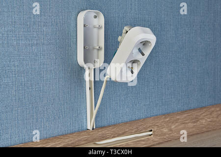 Process of mounting new electrical wall socket with copy space, residential wiring work. Stock Photo