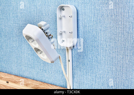 Duplex receptacle outlet in process of installing, electrical wiring services. Stock Photo