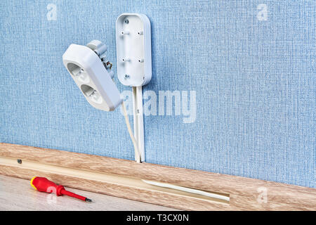 Duplex receptacle outlet in process of mounting, residential wiring work, close-up. Stock Photo