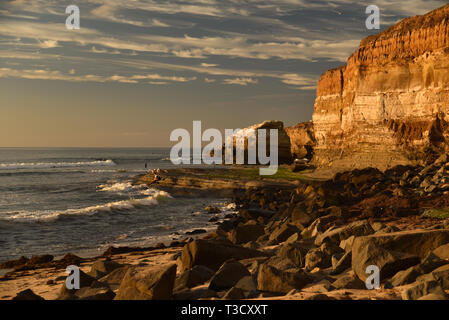 Waves from Pacific Ocean crashing on rocky shoreline along famous Sunset Cliffs, Point Loma, San Diego, CA, USA Stock Photo
