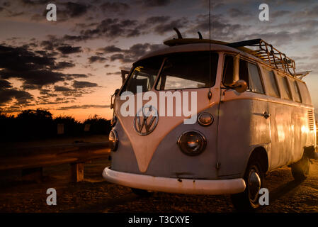 Vintage Volkswagon VW Microbus with rooftop rack for surfboards, parked along cliffs at Sunset Cliffs, San Diego, CA, USA Stock Photo