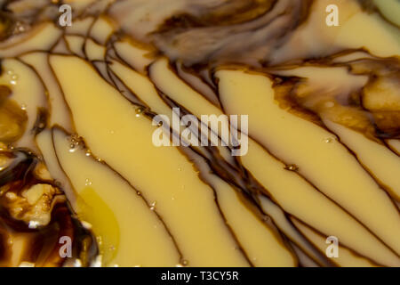 Close up of condensed milk and chocolate and butter melting on pan Stock Photo