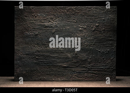 Grungy dark stucco wall with spotlight, background photo texture Stock Photo