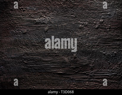 Grungy dark stucco wall with spotlight, background photo texture Stock Photo
