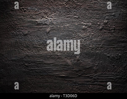 Grungy dark stucco wall with spotlight, background photo texture Stock Photo