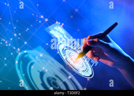 Business hand with markers touching a circle on virtual screen which display the interface of world maps, binary code and business network. Digital te Stock Photo