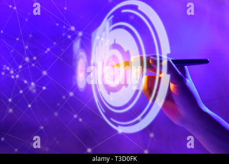 Business hand with markers touching a circle on virtual screen which display the interface of graphs and business network. Digital technology concept Stock Photo