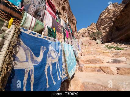 Detail of tourist gift stall with pashminas and other colourful woven local textiles at Petra, Jordan Stock Photo