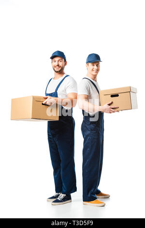 two handsome movers looking at camera while transporting cardboard boxes on white Stock Photo