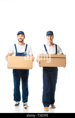two handsome movers looking at camera while transporting cardboard boxes on white Stock Photo