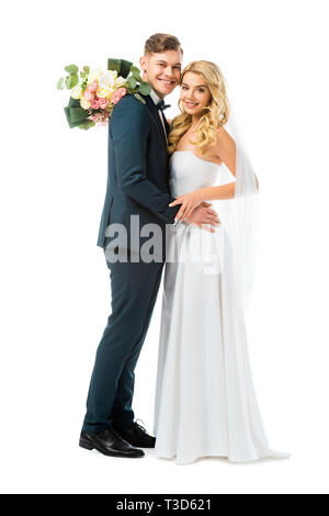 happy bride in long white wedding dress hugging smiling groom isolated on white Stock Photo