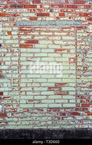 Shabby Building Facade Of Brick Wall With Damaged Old Plaster And Immured Window Stock Photo