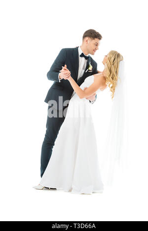 young groom in elegant suit dancing with happy bride isolated on white Stock Photo