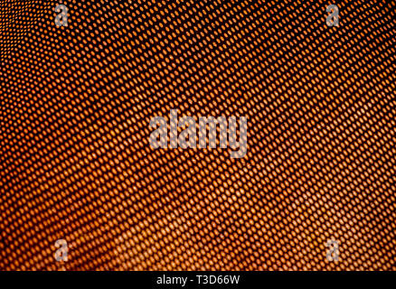 Shedow of perforated net on rusty metal sheet. Surface with depth of field. Horizontal abstract industrial mesh background Stock Photo