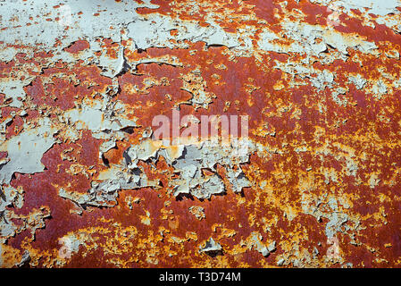 Texture of old rusty metal, painted white and partly peeling. Horizontal texture of cracked paint on rusty steel Stock Photo