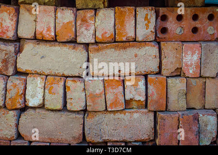 Texture Of Vintage Red Bricks Stacked. Blocks With Cement And Damages Stock Photo