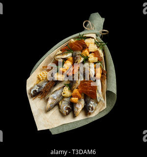 Gift to a real man in the form of a bouquet of dried fish and various snacks isolated on a black background Stock Photo