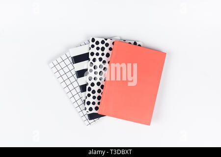 Creative top view flat lay of woman desk with different patterns notepads with copy space on white color paper background in minimal style. Template f Stock Photo