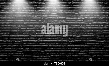 Highly contrasted spotlights on an outdoor black brick wall Stock Photo