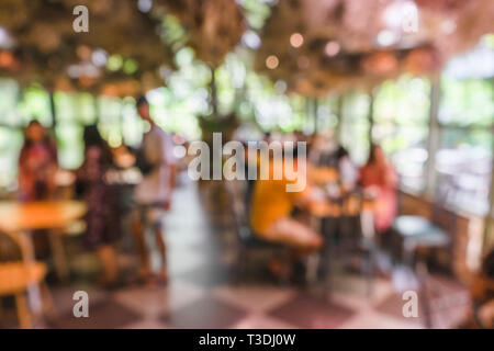 Blurred green nautre coffee shop or cafe restaurant with abstract bokeh light background. Stock Photo