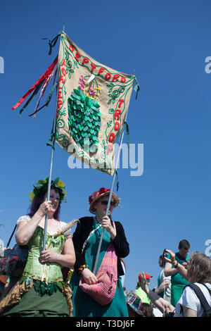 Two women in fancy dress carry the Deptford Women Troop banner, Jack in the Green procession, West Hill, Hastings, UK Stock Photo