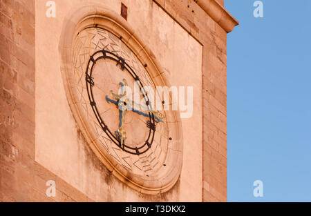 Warm sunset light on the bell tower clock of the Duomo of Cividale del Friuli, Italy Stock Photo