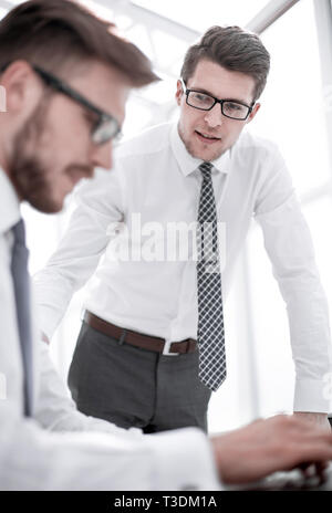 close up. employees working on a laptop and discussing something Stock Photo
