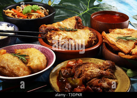 Assorted Chinese food set. Chinese noodles, fried rice, peking duck, dim sum, spring rolls. Famous Chinese cuisine dishes on table. Chinese restaurant Stock Photo