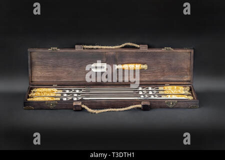Big luxury stainless steel skewers set in wooden box for grill and barbecue. Expensive high quality exlusive gift for man hunter Stock Photo