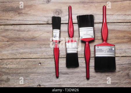 Paint Brushes on Wooden Background Stock Photo