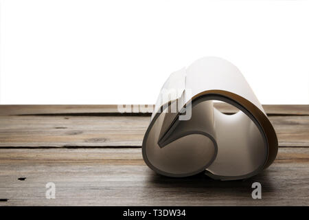 Rolled Up Blank Book on Wooden Background Stock Photo